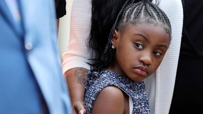 A family member holds onto Gianna Floyd, daughter of George Floyd, at the White House following their meeting with President Biden in Washington. Reuters