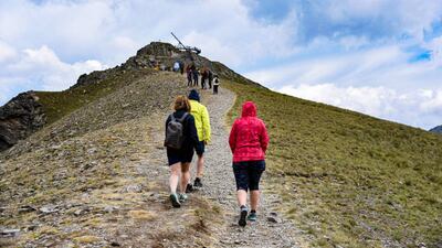 People walk up a steep path that accesses the Tristaina Solar Viewpoint in Andorra. Getty