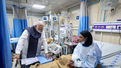 India's Prime Minister Narendra Modi visits people injured when a car exploded in New Delhi, killing 13. AFP