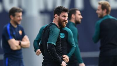Lionel Messi looks on as teammates train. David Ramos / Getty Images