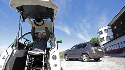 Frantisek Trunda reaches for the steering wheel of his Elbee vehicle. David W Cerny / Reuters