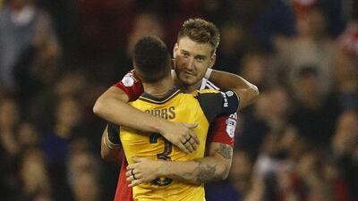 Arsenal’s Kieran Gibbs hugs Nottingham Forest’s Nicklas Bendtner after the game. John Sibley / Action Images / Reuters