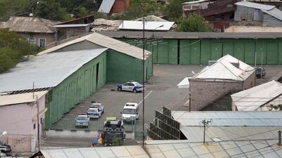 Police vehicles are stationed outside the Erebuni police station in Yerevan where gunmen shot dead an officer on July 30, 2016. Karen Minasyan/AFP