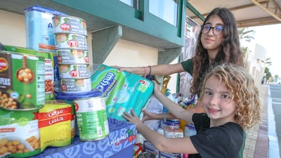 Eighth-year pupil Masa Oklah, and Aspen Murray, who is in the third year, during the aid collection drive for Gaza at the American Community School of Abu Dhabi. Victor Besa / The National