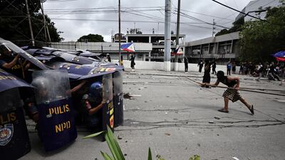 Protesters clash with anti-riot police during a rally in Manila, Philippines. EPA