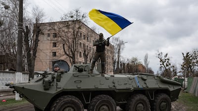 A Ukrainian soldier waves the national flag in Hostomel in 2022. Getty Images