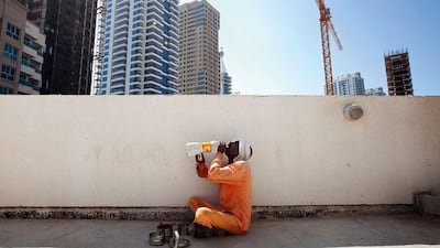 A labourer takes a lunch break outside his worksite in Dubai Marina. Jaime Puebla / The National