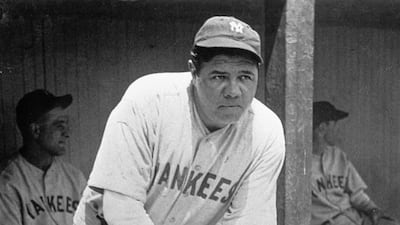 In this July 1929 file photo, New York Yankees' Babe Ruth, who was injured, stands in the dugout during a game at Cleveland. A Babe Ruth road jersey dating to 1928-30 has sold at auction for $5.6 million. AP Photo