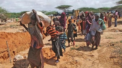 Somalis from southern Somalia carrying their belongings make their way to the new camp in southern Mogadishu's Hosh neighborhood Tuesday, July 12, 2011. Thousands of people have arrived in Mogadishu over the past two weeks seeking assistance and the number is increasing by the day, due to lack of water and food. The drought in the Horn of Africa has sparked a severe food crisis and high malnutrition rates, with parts of Kenya and Somalia experiencing pre-famine conditions, the United Nations has said. More than 10 million people are now affected in drought-stricken areas of Djibouti, Ethiopia, Kenya, Somalia and Uganda and the situation is deteriorating. (AP Photo/Farah Abdi Warsameh) .