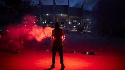 A Paris Saint-Germain fan taunts French riot police. Getty