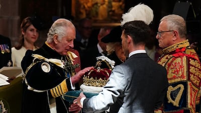 King Charles III is presented with the Crown of Scotland at a service of thanksgiving and dedication at St Giles' Cathedral in Edinburgh. Getty Images