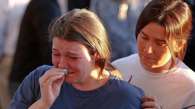 The 19-year-old man arrested after a mass shooting at a school in Florida has been charged with 17 counts of murder as authorities faced growing questions about why they failed to act on a string of warning signs. Brynn Anderson / AP Photo