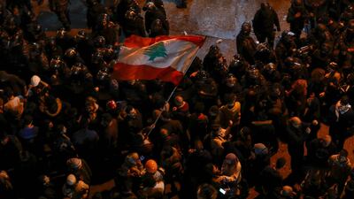 Protesters gather at the entrance of a police barracks housing the detainees who were arrested overnight, in Beirut. AFP