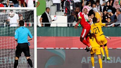 Palestine's Abdellatif Bahdari, left, fights for the ball with Australia's Awer Mabil. AFP