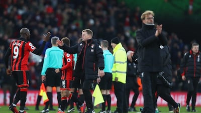 Eddie Howe, manager of Bournemouth, centre, celebrates victory with Benik Afobe as Liverpool manager Jurgen Klopp, right, applauds fans after his side's 4-3 defeat at the Vitality Stadium on December 4, 2016 in Bournemouth, England. Bryn Lennon / Getty Images
