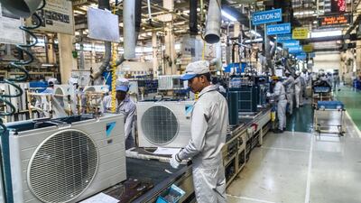 Employees work on the outdoor units of split system air conditioners on an assembly line at the Daikin Air Conditioning India Pvt. factory in Neemrana, Rajasthan, India. Bloomberg