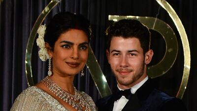 Newlyweds Priyanka Chopra, 36, and Nick Jonas, 26, pose for a photograph during a reception at a hotel in New Delhi on December 4, 2018. Photo: AFP