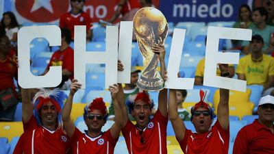 Chile fans hold up a cut out of the World Cup trophy as they wait for the start of the 2014 World Cup Group B match against Spain on Wednesday. Pilar Olivares / Reuters