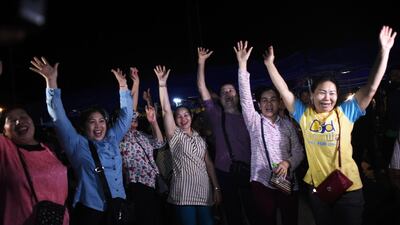 Volunteers celebrate at a makeshift press centre in Mae Sai district of Chiang Rai province on July 10, 2018, after the twelve boys and their football coach were rescued. AFP/Ye Aung THU