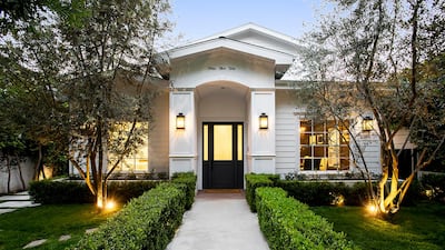 The home has an understated white facade. Courtesy Engel & Volkers