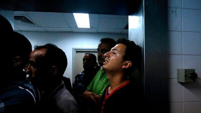 Relatives mourn over the body of Abdel Karim Radwan, who was killed in an Israeli air strike earlier today, at a hospital in Khan Yunis in the southern Gaza Strip on July 19, 2018. AFP