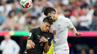Iran's Saeid Ezatolahi in action with New Zealand's Marko Stamenic, in Los Angeles. Reuters