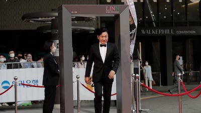 South Korean actor Ahn Sung-ki walks through a thermal camera system to check his body temperature. AP