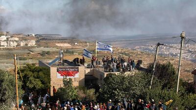 Israeli settlers barricade themselves inside a structure during the evacuation. Abir Sultan / EPA