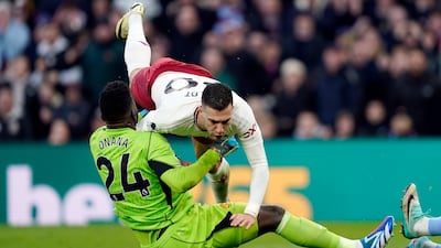 Manchester United's Diogo Dalot collides with his keeper Andre Onana. EPA