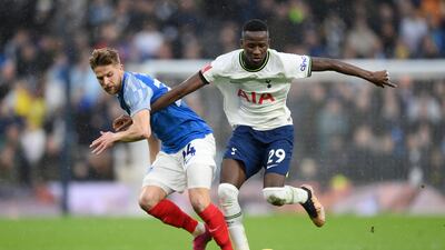 Pape Matar Sarr of Tottenham battles for possession with Michael Jacobs of Portsmouth. Getty