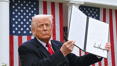 US President Donald Trump holds a signed executive order after delivering remarks on reciprocal tariffs during an event at the White House. AFP