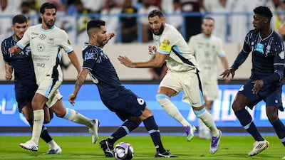 Karim Benzema, centre, in action against Al Okhdood. Photo: Al Ittihad Club
