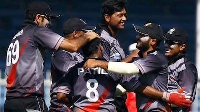 The UAE team celebrates the dismissal of Fraser Watts of Scotland.