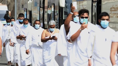 Muslim pilgrims enter Namira Mosque in Arafat, as they wear masks and keep social distance to protect themselves against the coronavirus. AP Photo
