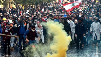 Anti-government protesters clash with Lebanese riot police outside of the Parliament in downtown Beirut. EPA