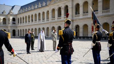 Sheikh Mohamed and Mr Le Cornu stand at attention as the two countries' anthems are played. Photo: Presidential Court