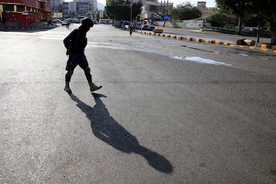 A Houthi soldier patrols a street in Sanaa. Houthi forces have detained UN personnel. EPA
