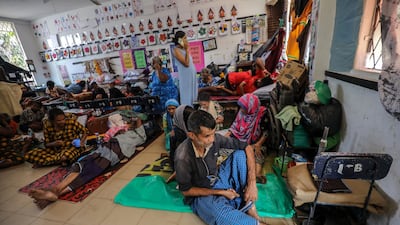 Sri Lankans have sheltered in schools after fleeing the floods. EPA