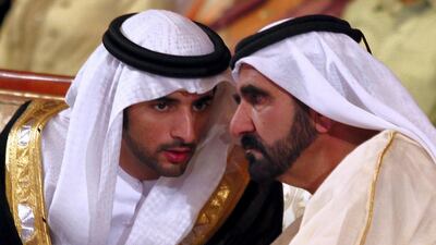 Sheikh Mohammed bin Rashid speaks with his son Sheikh Hamdan during the opening session of Arab Media Forum in Dubai, on May 17, 2011. AFP