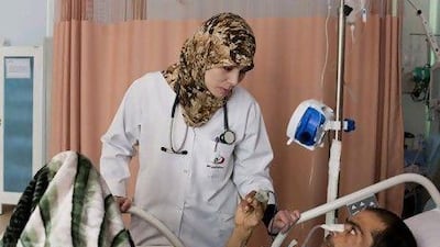 Dr Jasmine Sherif treats a man who was injured fighting in the streets of Benghazi. Ivor Prickett for The National