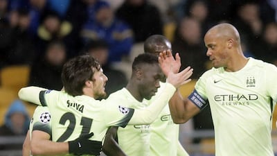 Manchester City's David Silva, left, is congratulated by teammate Vincent Kompany after a goal in their 3-1 win over Dynamo Kiev in the Champions League on Wednesday night. Efrem Lukatsky / AP / February 24, 2016