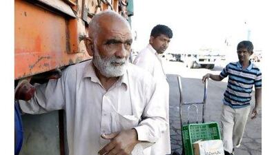 Farman Allah, who has been a lorry driver for 15 years, stops at Mirfa before resuming his 1,900km journey to Jeddah. Sammy Dallal / The National
