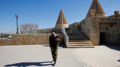 A Yazidi fighter walks near Yazidi temple Sharaf Al Din, in Sinjar. Reuters, file