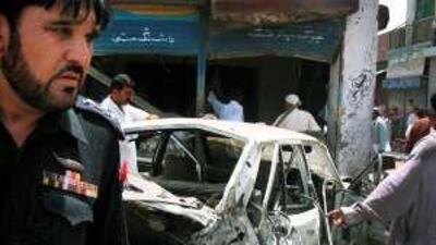 Security officials inspect the site of a bomb blast that killed at least six people and wounded 15 at a market yesterday in Dera Ismail Khan, a town in north-west Pakistan that has been repeatedly hit by Taliban attacks during the militant group's offensive against government troops.