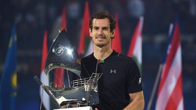 Andy Murray poses with the trophy after winning the Dubai Duty Free Tennis Championships title. Tom Dulat / Getty Images