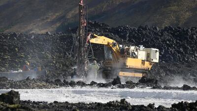 Construction workers drill near geothermal waters of the Blue Lagoon near Reykjavik. Matt Cardy / Getty Images