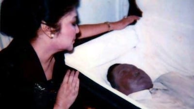Philippine former first lady Imelda Marcos looks inside the coffin of her late husband and former president, Ferdinand, in Hawaii. Mr Marcos’s body, now on display at a family mausoleum, has been injected with a special cavity fluid to preserve it for 25 years.