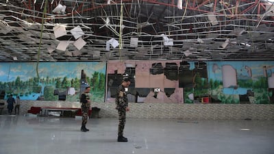 Afghan soldiers inspect a damaged Dubai City wedding hall after an explosion in Kabul, Afghanistan. AP