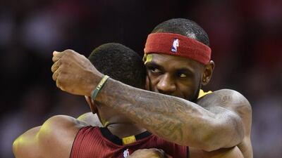 The Cleveland Cavaliers forward LeBron James, right, is greeted by former teammte Dwyane Wade of the Miami Heat on Thursday night. EPA/RHONA WISE