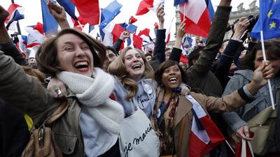Macron supporters celebrate in front of the glass pyramid at the Louvre Museum in Paris on May 7, 2017, following the announcement of the results of the second round of the French presidential election. Patrick Kovarik / AFP